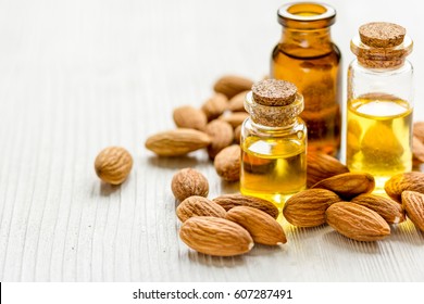 natural oil and almond in cosmetic set on table background