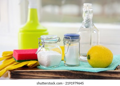 Natural Organic Eco Friendly Home Cleaning Tools Ingredients, White Vinegar, Lemon, Baking Soda, Citric Acid On Wood Tray On Window Sill, Window On Background.