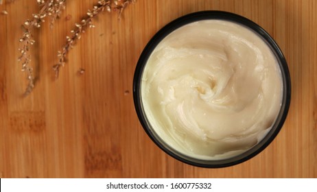 natural organic shea butter on a wooden background