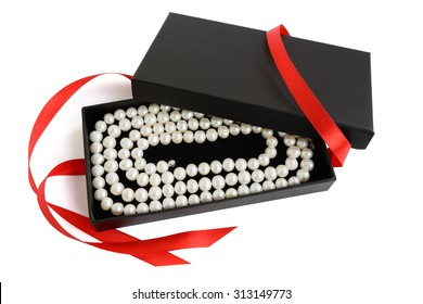 Natural Pale Pearl Necklace In Open Black Gift Box With Red Satin Ribbon, Isolated On White