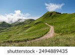 Natural path leading to the Puy de Sancy, highest mountain in the Massif Central, in Puy-de-Dôme departement of south central France. Cloud hanging from the summit like the smoke of a volcano.