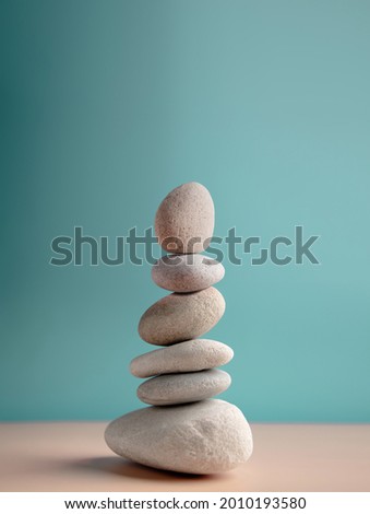 Natural Pebble, Stone Stack. Metaphor of Balancing Body, Mind, Soul and Spirit. Mental Health Practice. Harmony, Calm, Mind, Life Relaxing and Living by Nature Concept. Vertical image