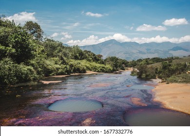 Natural phenomenon of Quebrada las Gachas in Guadalupe, Colombia. These are natural plunge pools of up to 6ft in the purple algae bloom covered riverbed