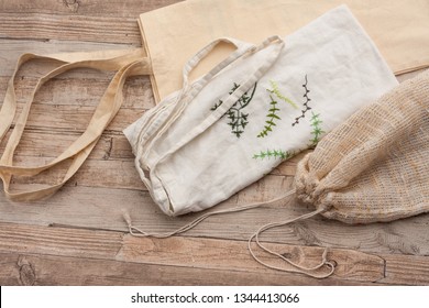 Natural, Plastic Free Recycled Textile Produce Bag For Carrying Fruit Or Vegetables On A Wooden Surface. Reusable, Recyclable Cotton, Textile Bags For Zero Waste Grocery Shopping.