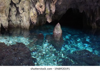 natural pool in a remote cave with stalactites and stalagmites 
