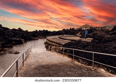 Natural pools at Biscoitos during a dramatic sunset in the coast of Terceira Island, Azores, Portugal