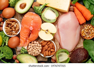 Natural, protein-rich food, Meat, fish, nuts and beans on a stone background. Healthy food concept