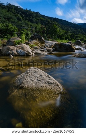 a natural pure small stream river from wellspring from the high mountain flowing through rock basin 