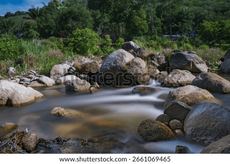 a natural pure small stream river from wellspring from the high mountain flowing through rock basin 
