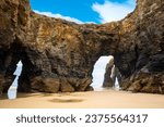 Natural rock arches Cathedrals beach, Playa de las Catedrales at Ribadeo, Galicia, Spain. Famous beach in Northern Spain Atlantic. Natural rock arch on Cathedrals beach in low tide