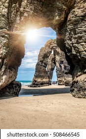 Natural rock arches Cathedrals beach (playa de las catedrales). Famous beach in Northern Spain Atlantic. Natural rock arch on Cathedrals beach in low tide (Cantabric coast, Lugo (Galicia), Spain).