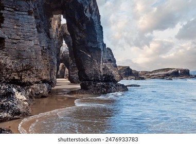 Natural rock arches on Cathedrals beach  in low tide (Cantabric coast, Lugo (Galicia), Spain). - Powered by Shutterstock