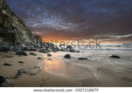 Natural rocks in the sea with beautiful sunset sky on the beach of Silistar, Bulgaria