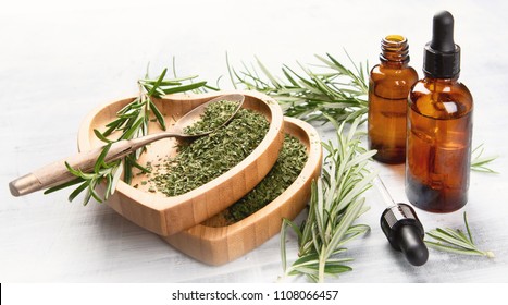 Natural rosemary essential oil with fresh rosemary twigs 