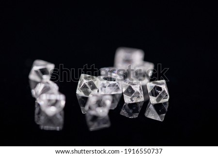 Natural Rough diamonds on black background sorted by size and shapes . High quality photoNatural 
