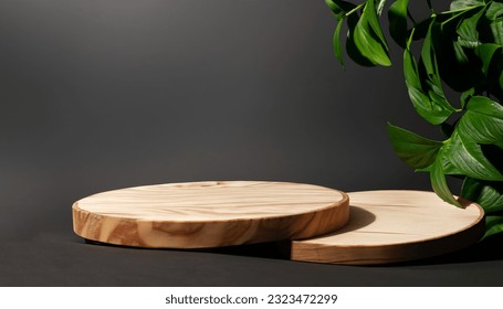 Natural round wooden stand for presentation and exhibitions on black background with shadow. Copy space. - Shutterstock ID 2323472299