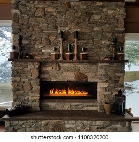 Natural, Rustic, Stone Fireplace With Roaring Flames in Winter - Shutterstock ID 1108320200