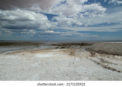 Natural salt flats. Industry and open cast mining. Saltworks and salt natural fields under a dramatic and stormy sky. - Powered by Shutterstock