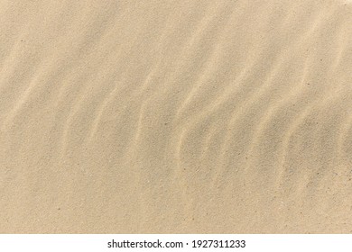 Natural sand stone texture background. sand on the beach as background. Wavy sand background for summer designs.