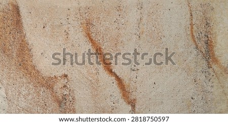 Natural sandstone texture with deep, rust-colored streaks.