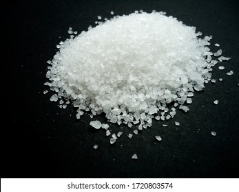 natural sea salt grains on dark background