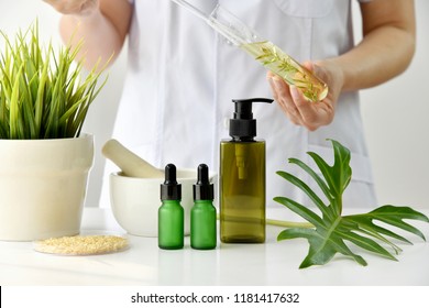 Natural Skincare Cosmetics Research And Development Concept, Doctor Formulating New Beauty Products From Organic Natural Plants, Pharmacist Mixing Extract Essence Substance In Test Tube.