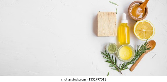 Natural skincare ingredients with manuka honey, lemon, essential oil, clay, balm, rosemary herbs and natural soap, healthy wellness and spa products , natural and homemade ingredients with copy space 