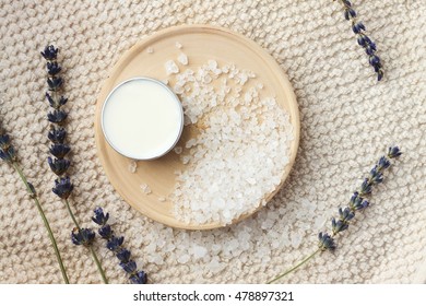 Natural Skincare Ingredients. Sea Salt, Dried Lavender, Facial Moisturizer, Beige Towel. DIY Beauty Hacks