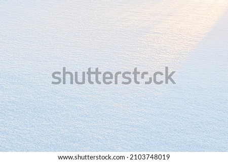 Natural snow texture. Smooth surface of clean fresh snow. Snowy ground. Winter background with snow patterns.  texture for background and design.