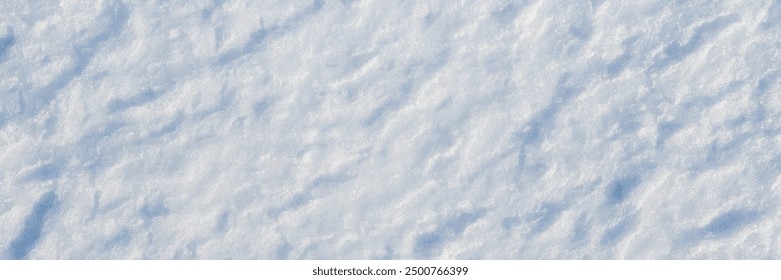 Natural snow texture. The surface of the snow crust. Snowy ground. Winter background with snow patterns. Perfect for Christmas and New Year design. Closeup top view.