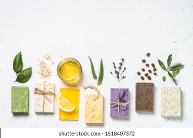 Natural Soap Bars With Ingredients. Aloe, Lavender, Eucalyptus, Olive, Honey, Coffee, Tee Tree Oil And Oat Soaps. Flat Lay Image With Copy Space.