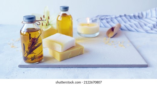 Natural soap, white lily flower, aromatic oil, burning candles and sea salt on the table, spa, natural cosmetics for body care and relaxation 