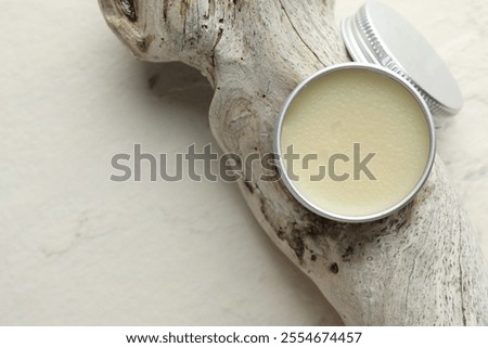 Natural solid perfume in container and snag on white background, top view. Space for text