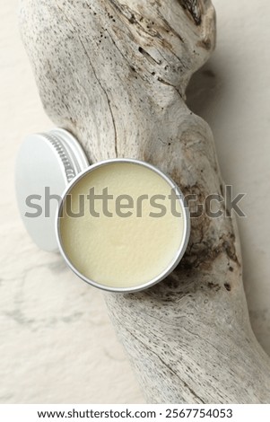 Natural solid perfume in container and snag on white background, top view
