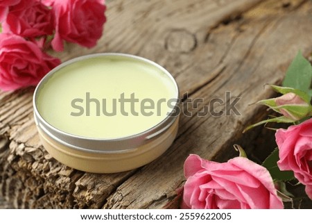 Natural solid perfume and pink roses on wood, closeup