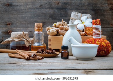 Natural Spa ingredients and herbal compress ball for alternative medicine and relaxation. Thai Spa theme with ayurvedic therapist on shabby wooden background.
