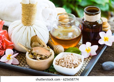 Natural Spa Ingredients herbal compress ball and herbal Ingredients for alternative medicine and relaxation .Spa background with wooden background.