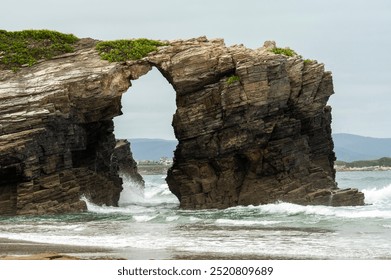 Natural Stone Archway Carved by the Ocean Waves - Powered by Shutterstock