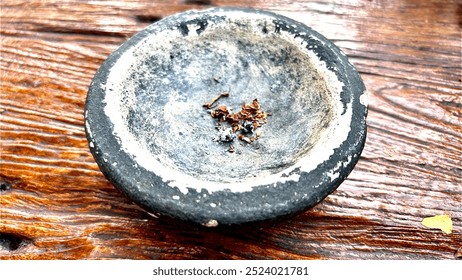 natural stone ashtray, a bowl model and coated with white cement on a brown wooden table - Powered by Shutterstock