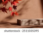 
Natural stone podium with falling autumn leaves in front of beige background. Fall season, thanksgiving and seasonal home decor scene. Premium brand product placement showroom stage.