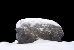 Natural Stone In Snow Isolated On Black Background. High Quality Photo