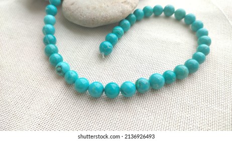 
natural stone turquoise close-up on a white background. natural turquoise beads