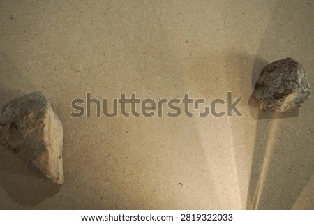 Natural stones and dramatic sunlight shadow on wooden board back
