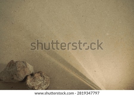 Natural stones and dramatic sunlight shadow on wooden board back