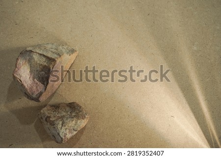 Natural stones and dramatic sunlight shadow on wooden board back