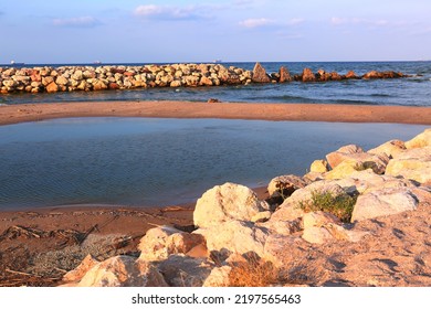 Natural Stony Beach Landscape In Spain With Sand Spit Close Up Photo