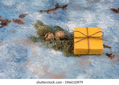 Natural Sulfur Soap With Pine Branches And Cones On A Blue Tumbled Floor