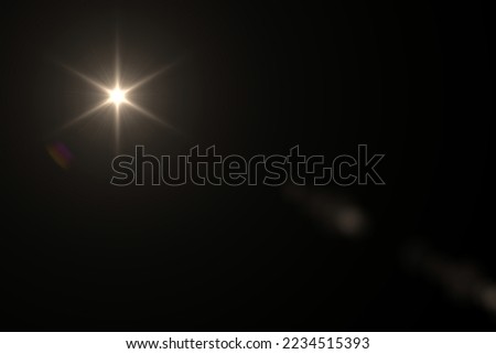 Natural Sun flare on the black background. Optical lens flare.