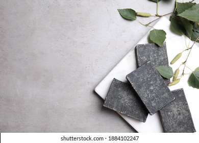 Natural Tar Soap Bars And Birch Branches On Light Grey Stone Table, Flat Lay. Space For Text