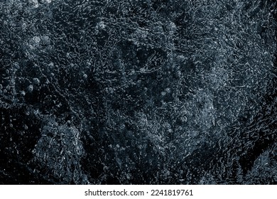 Natural textured ice surface black background.